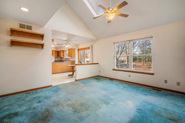 unfurnished living room with visible vents, baseboards, light colored carpet, and a skylight