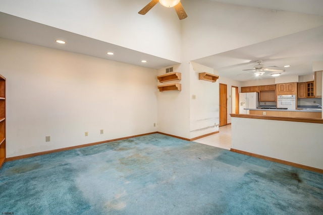 unfurnished living room featuring light colored carpet, baseboards, and ceiling fan