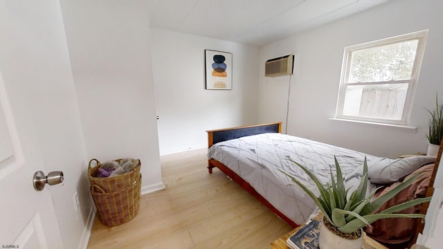 bedroom with light wood-style flooring and baseboards