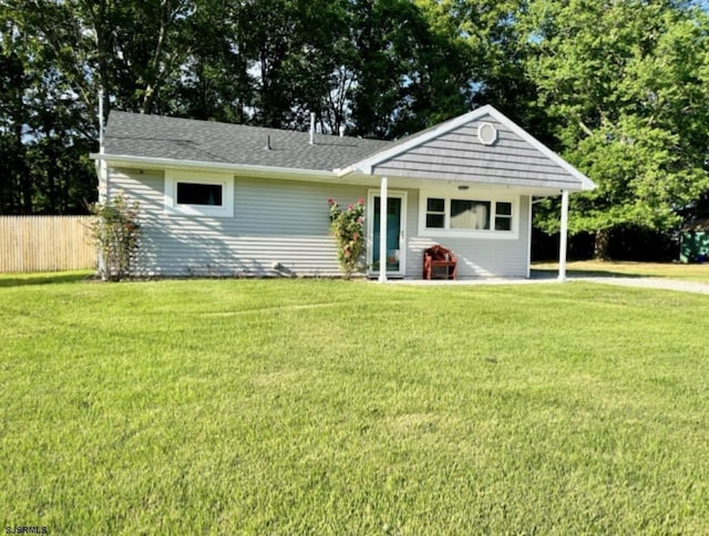 view of front of property with a front yard and fence