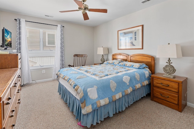 bedroom with visible vents, light colored carpet, and baseboards