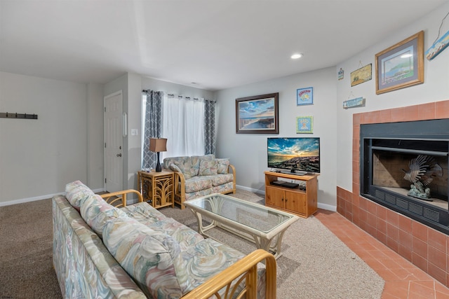 living room with recessed lighting, baseboards, and a tile fireplace