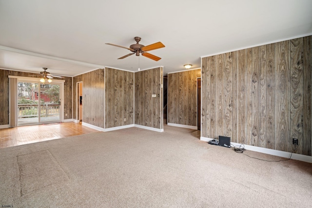 carpeted empty room with crown molding, baseboards, and ceiling fan