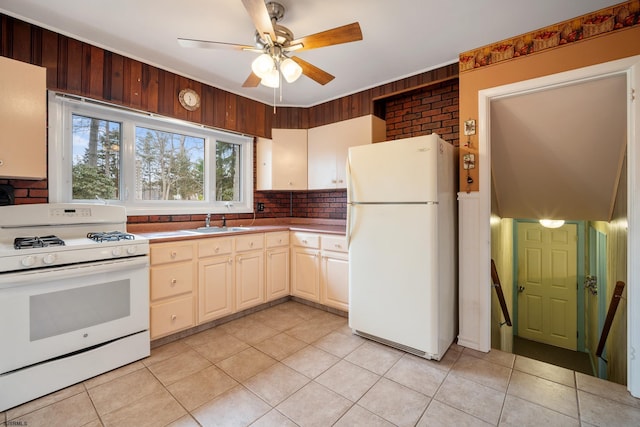 kitchen with white appliances, light tile patterned floors, a ceiling fan, a sink, and decorative backsplash