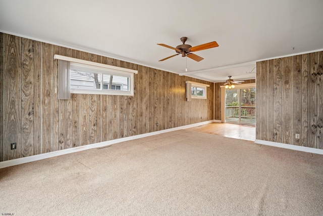 unfurnished room featuring baseboards, carpet floors, and a ceiling fan