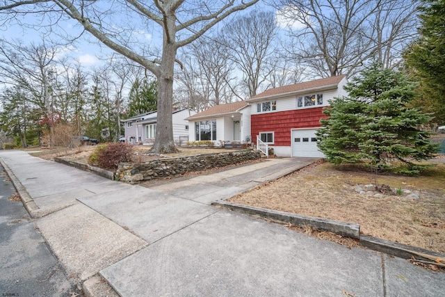 view of front of home with driveway and a garage