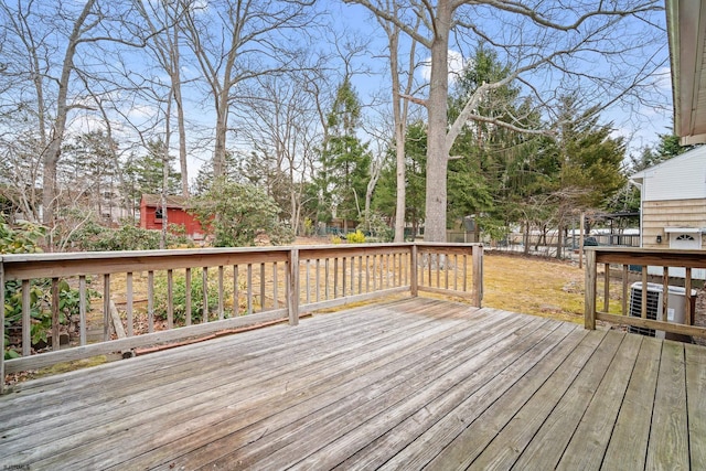 wooden terrace with a yard, fence, and central AC