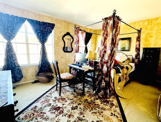 bedroom with carpet flooring, wallpapered walls, and baseboards