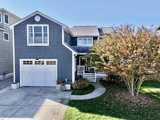 traditional-style house with driveway, an attached garage, and a front lawn