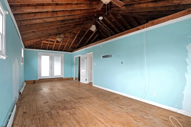 unfurnished room featuring a baseboard radiator, wood finished floors, visible vents, and ceiling fan