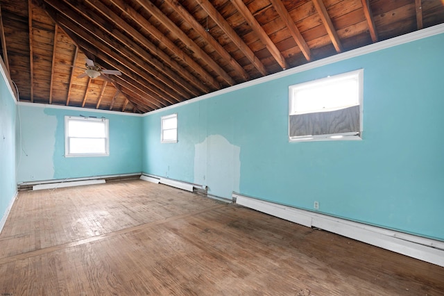 empty room featuring lofted ceiling with beams, a baseboard heating unit, wood ceiling, and wood finished floors