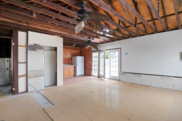 interior space with a ceiling fan and freestanding refrigerator