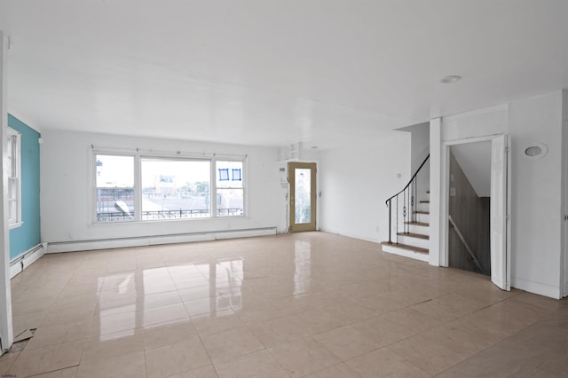 unfurnished living room with tile patterned floors, a baseboard heating unit, and stairway