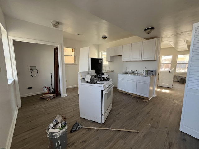 kitchen featuring baseboards, dark wood-type flooring, white cabinets, and white gas range oven