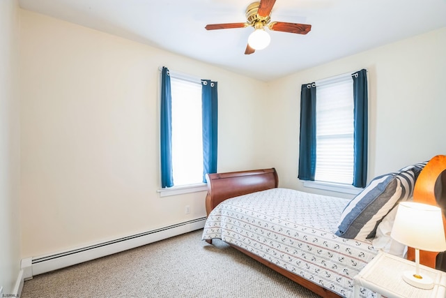 carpeted bedroom with baseboard heating and ceiling fan