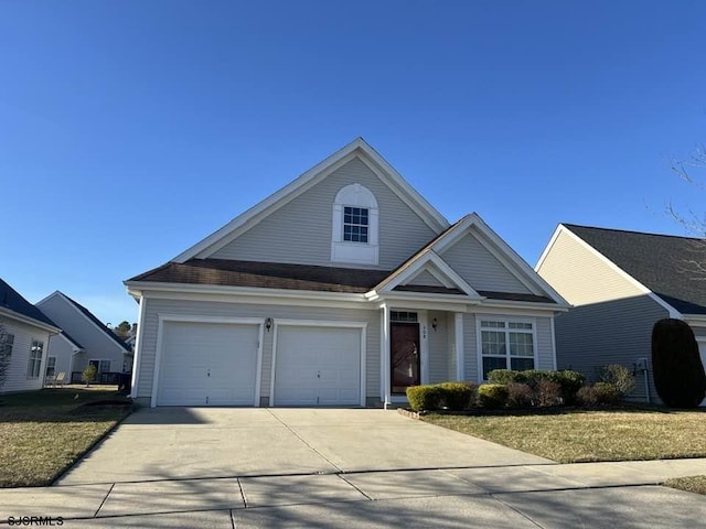 view of front of house with concrete driveway and a front lawn