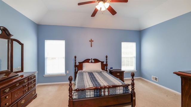 bedroom featuring vaulted ceiling, baseboards, visible vents, and light carpet