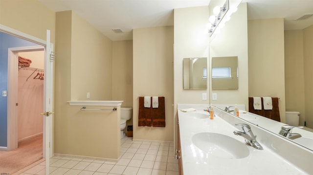 bathroom with toilet, visible vents, and a sink