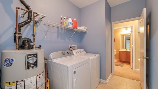 laundry room with washing machine and dryer, gas water heater, laundry area, and baseboards