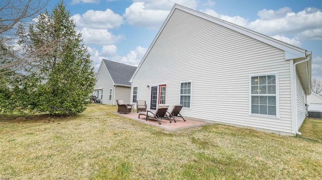 back of house featuring a lawn and a patio