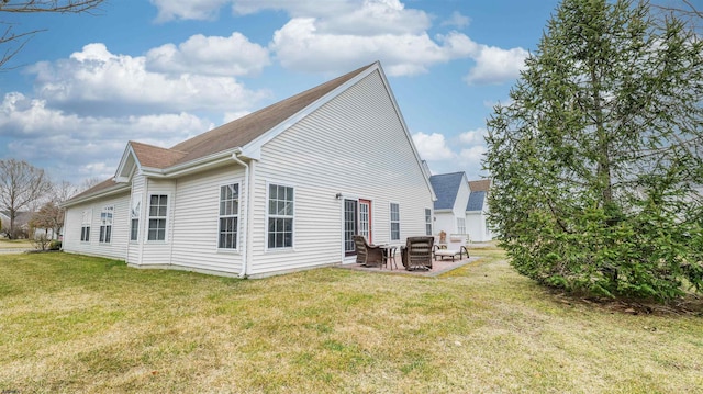 rear view of property with a yard and a patio