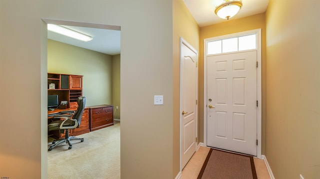 interior space with light carpet and baseboards