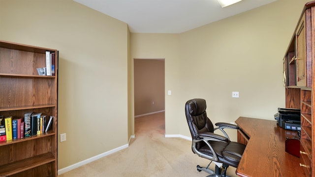 office area featuring baseboards and light colored carpet