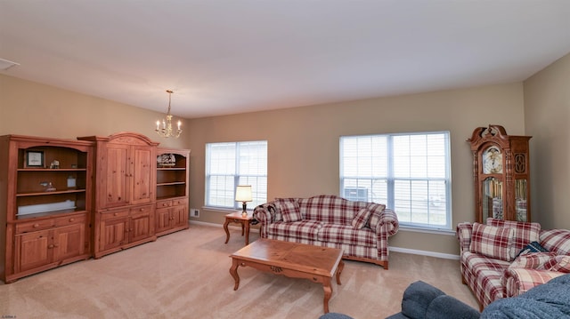 living area featuring plenty of natural light, light colored carpet, and an inviting chandelier