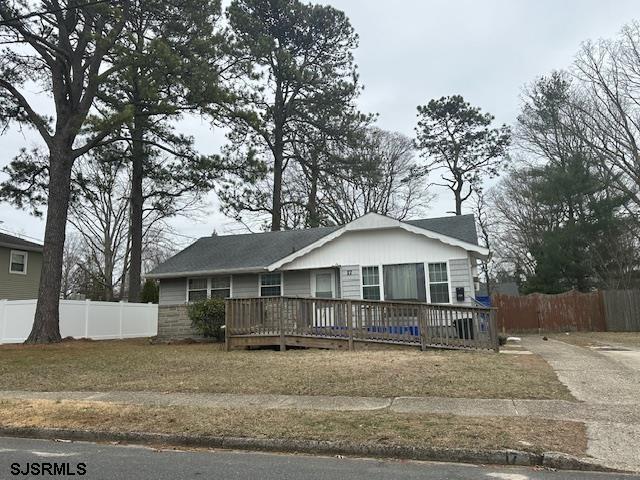 view of front of house with a wooden deck and fence