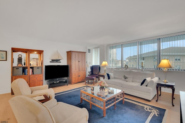 living room featuring baseboards and light wood finished floors