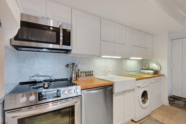 kitchen featuring wooden counters, tasteful backsplash, appliances with stainless steel finishes, and white cabinetry