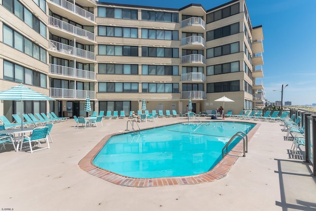 community pool with a patio area