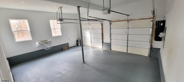 garage with electric panel, a garage door opener, and a wall unit AC