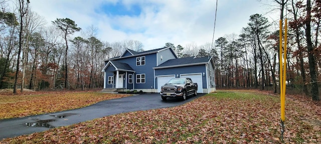 traditional home featuring an attached garage and driveway