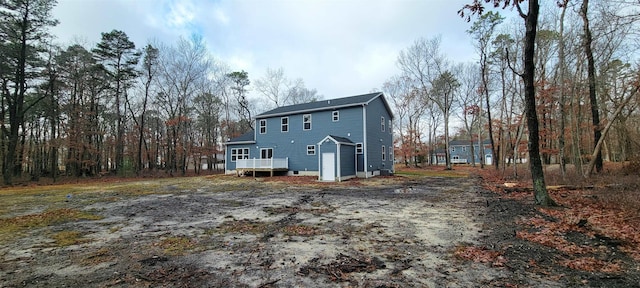 rear view of house with a wooden deck