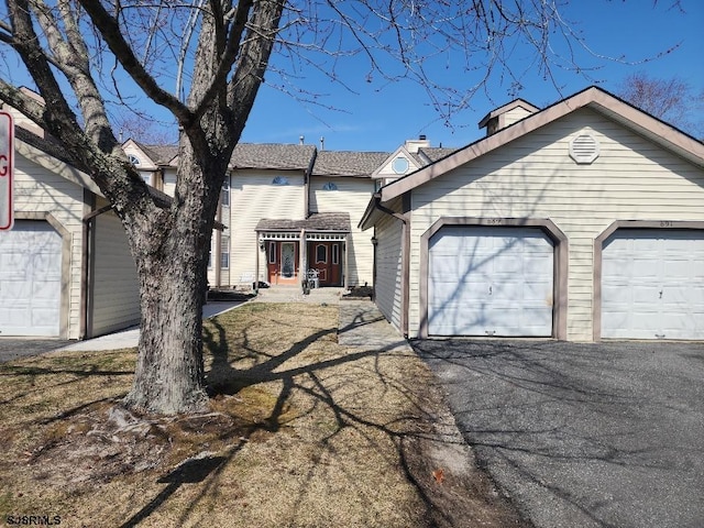 view of front of property featuring aphalt driveway and a garage