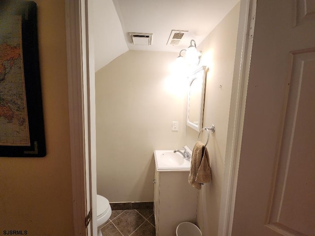 half bathroom featuring tile patterned floors, visible vents, toilet, and vanity