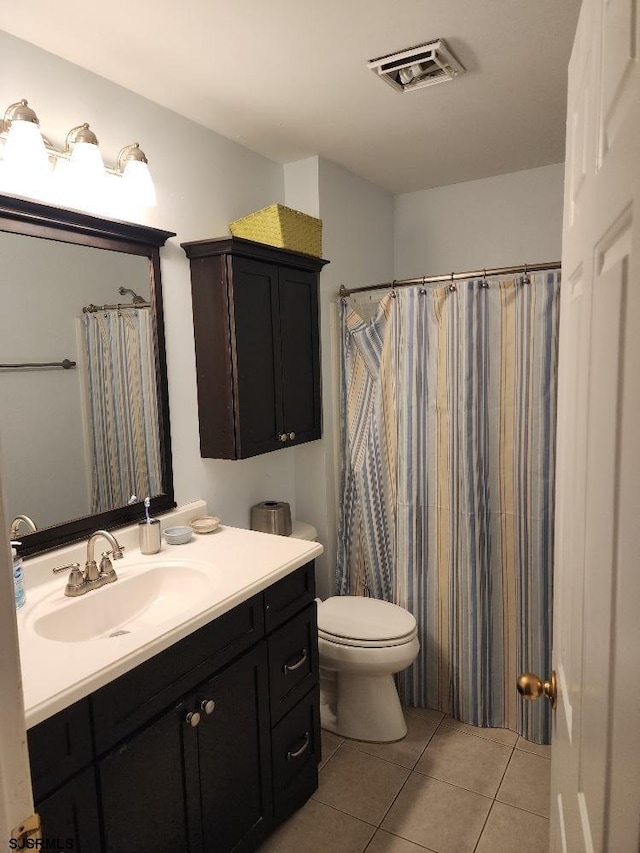 bathroom with tile patterned flooring, visible vents, toilet, and vanity