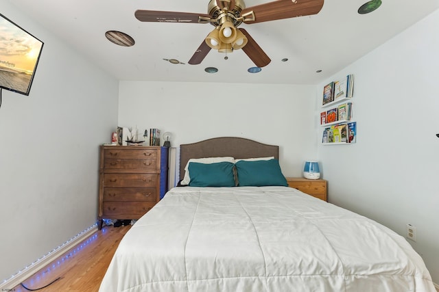 bedroom featuring wood finished floors and a ceiling fan