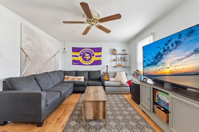 living room featuring a ceiling fan and light wood finished floors