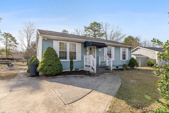 ranch-style house with concrete driveway and fence