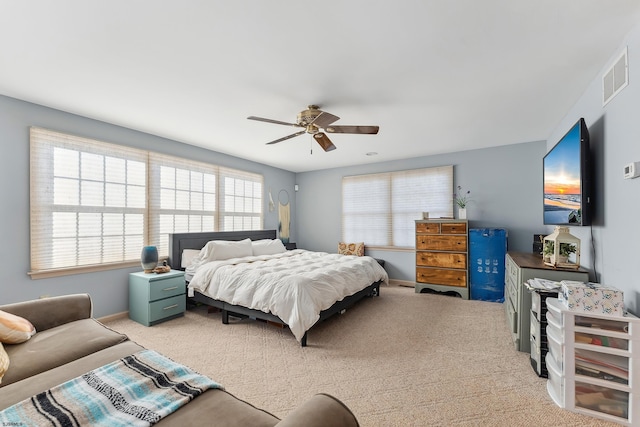 bedroom featuring visible vents, baseboards, carpet, and a ceiling fan