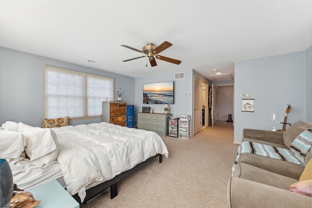 carpeted bedroom featuring visible vents and a ceiling fan