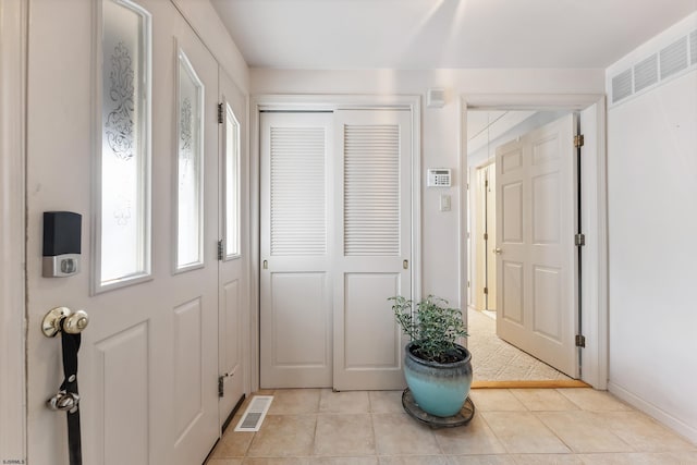 foyer with light tile patterned flooring and visible vents