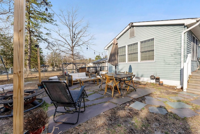 view of patio featuring an outdoor living space, outdoor dining space, and fence