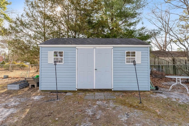 view of shed featuring fence