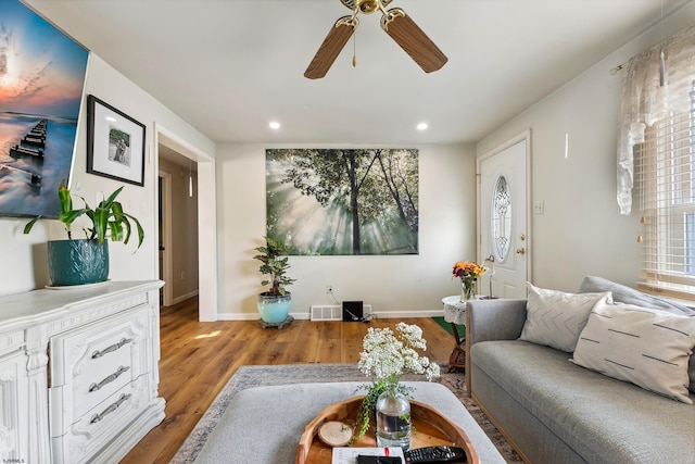 living area with wood finished floors, a ceiling fan, visible vents, baseboards, and recessed lighting