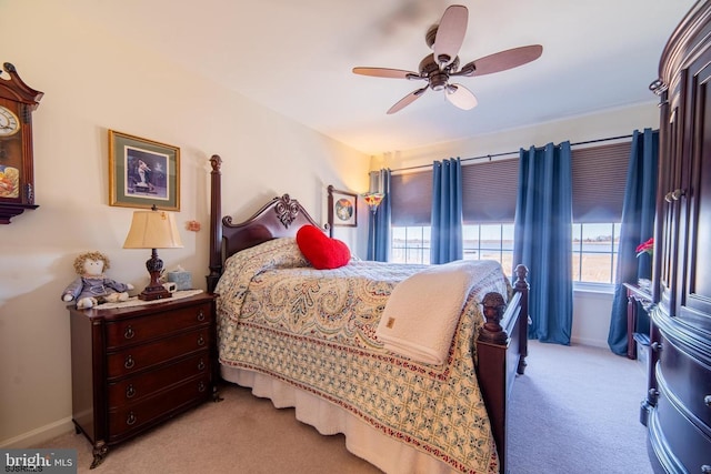 bedroom featuring light colored carpet, baseboards, and ceiling fan