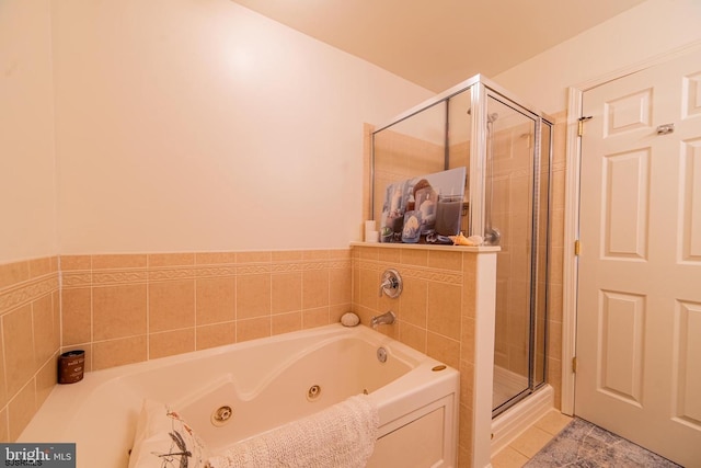 bathroom with tile patterned flooring, a shower stall, and a jetted tub