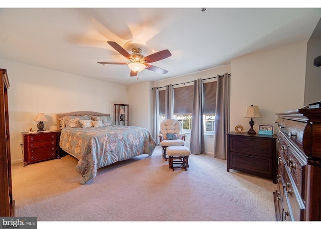 bedroom featuring light colored carpet and ceiling fan